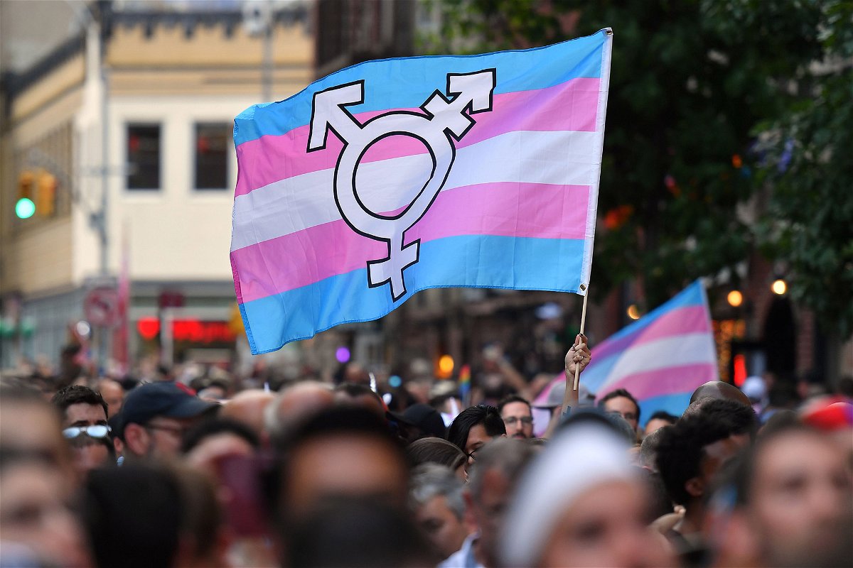 A person holds a transgender pride flag as people gather for a rally in this file photo.