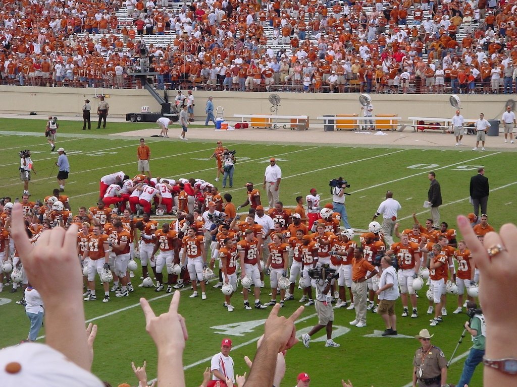 UT students and football players singing 