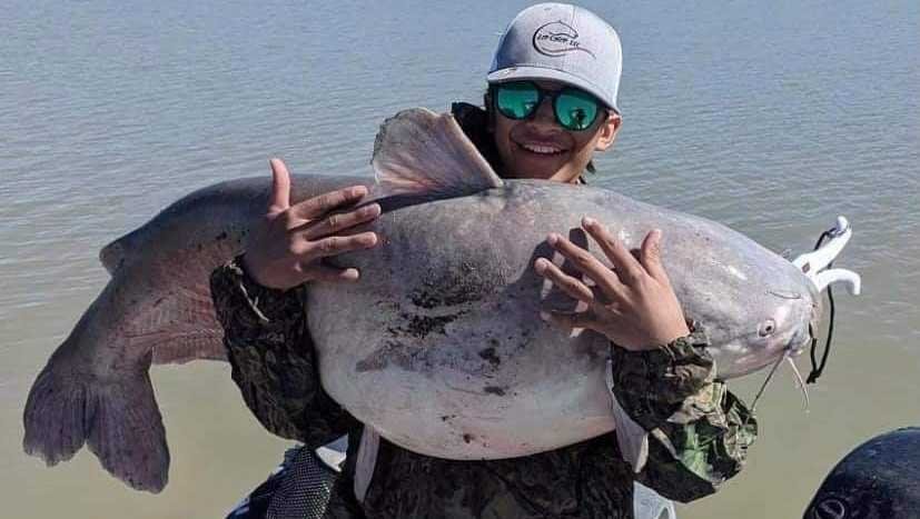 13-year-old Alonso Ordaz with his 55-pound blue catfish.