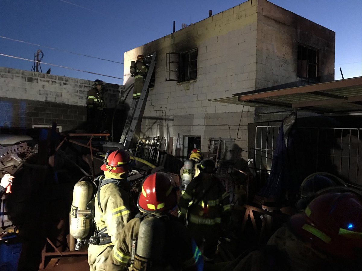 El Paso firefighters work to extinguish hot spots at a building fire in central.