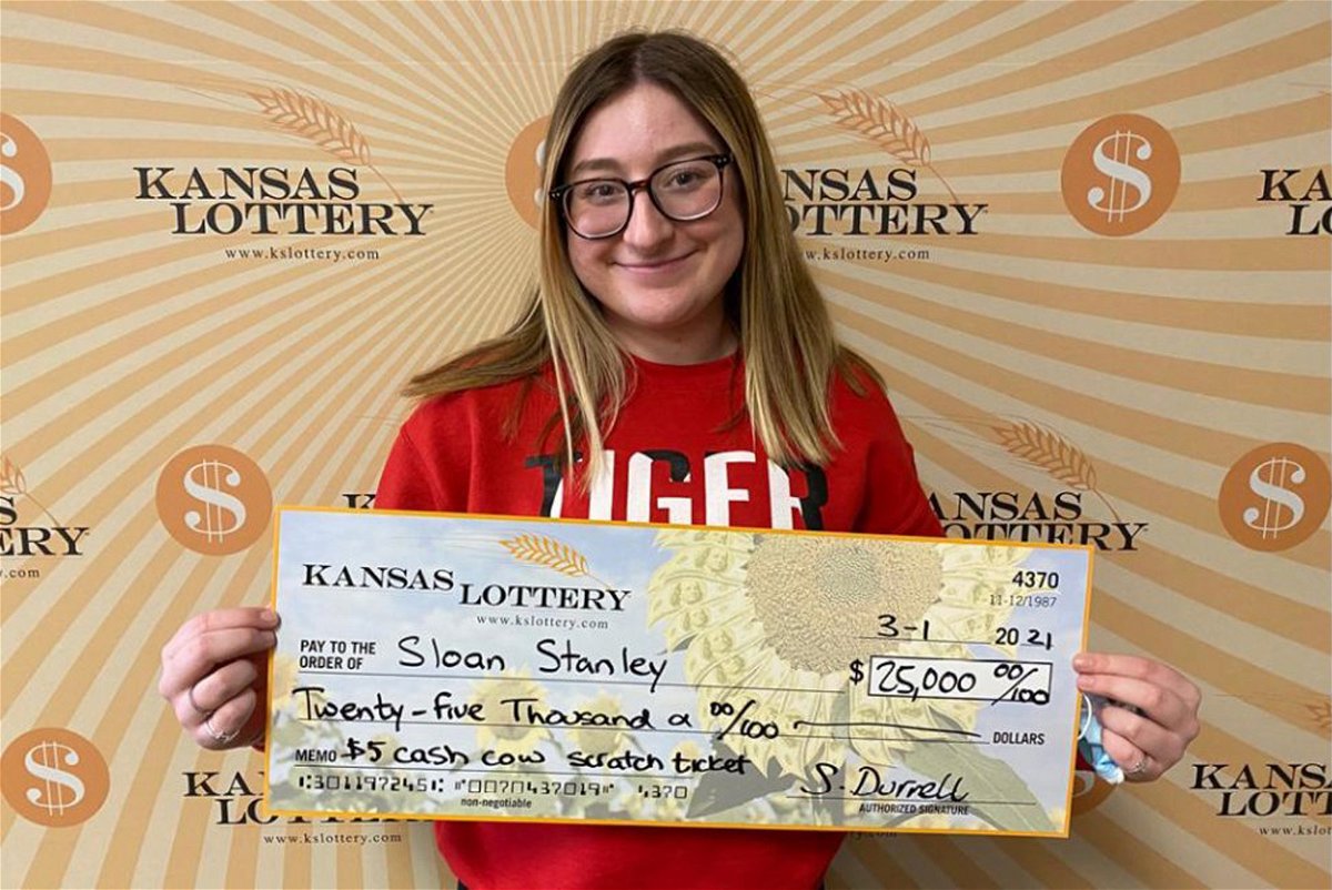 Sloan Stanley, 18, holds her $25,000 lottery check.