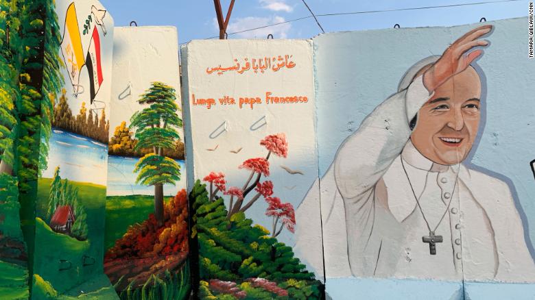 Blast walls surrounding the Our Lady of Salvation church in Iraq are adorned with murals of Pope Francis during the historic papal visit.