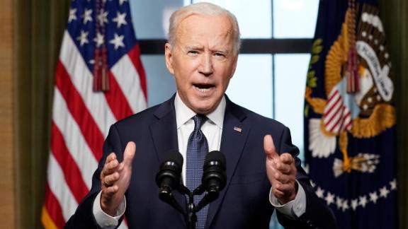 President Joe Biden gestures while making remarks.