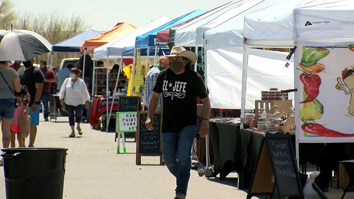 Visitors wander vendor displays at the Westside Country Club Farmers Market.