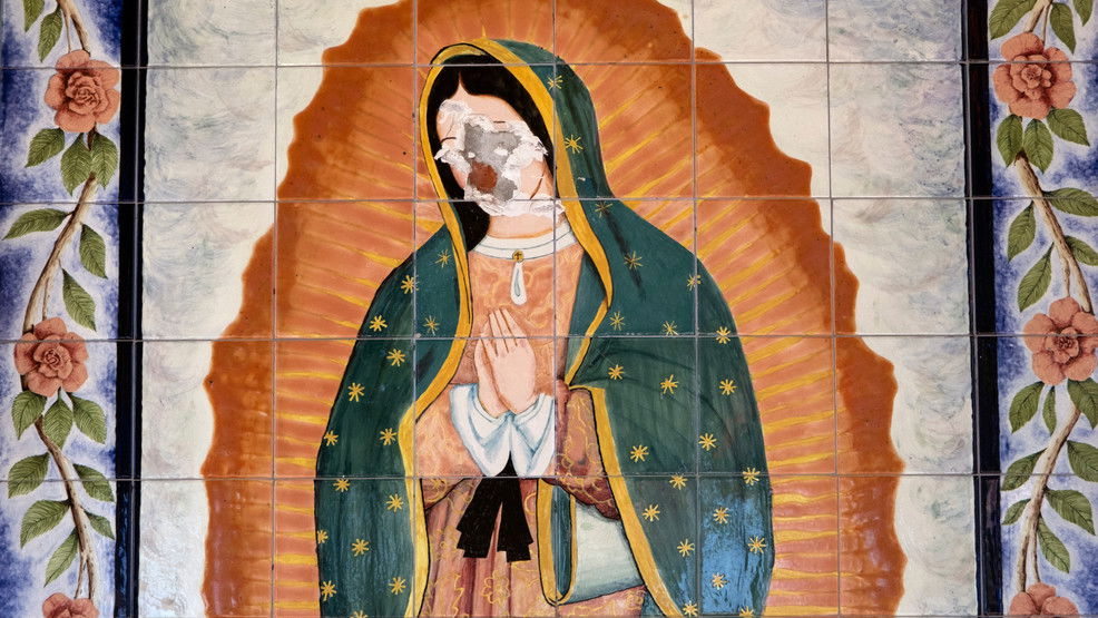 A Virgin of Guadalupe mural painted on tiles is seen with a destroyed face on the side of St. Elisabeth Catholic Church in the Van Nuys section of Los Angeles.