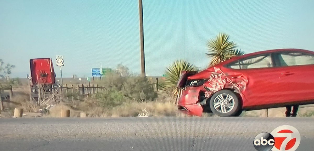 Scene of a crash on U.S. 54. The truck involved can be seen on the far left, while a damaged car is on the right.