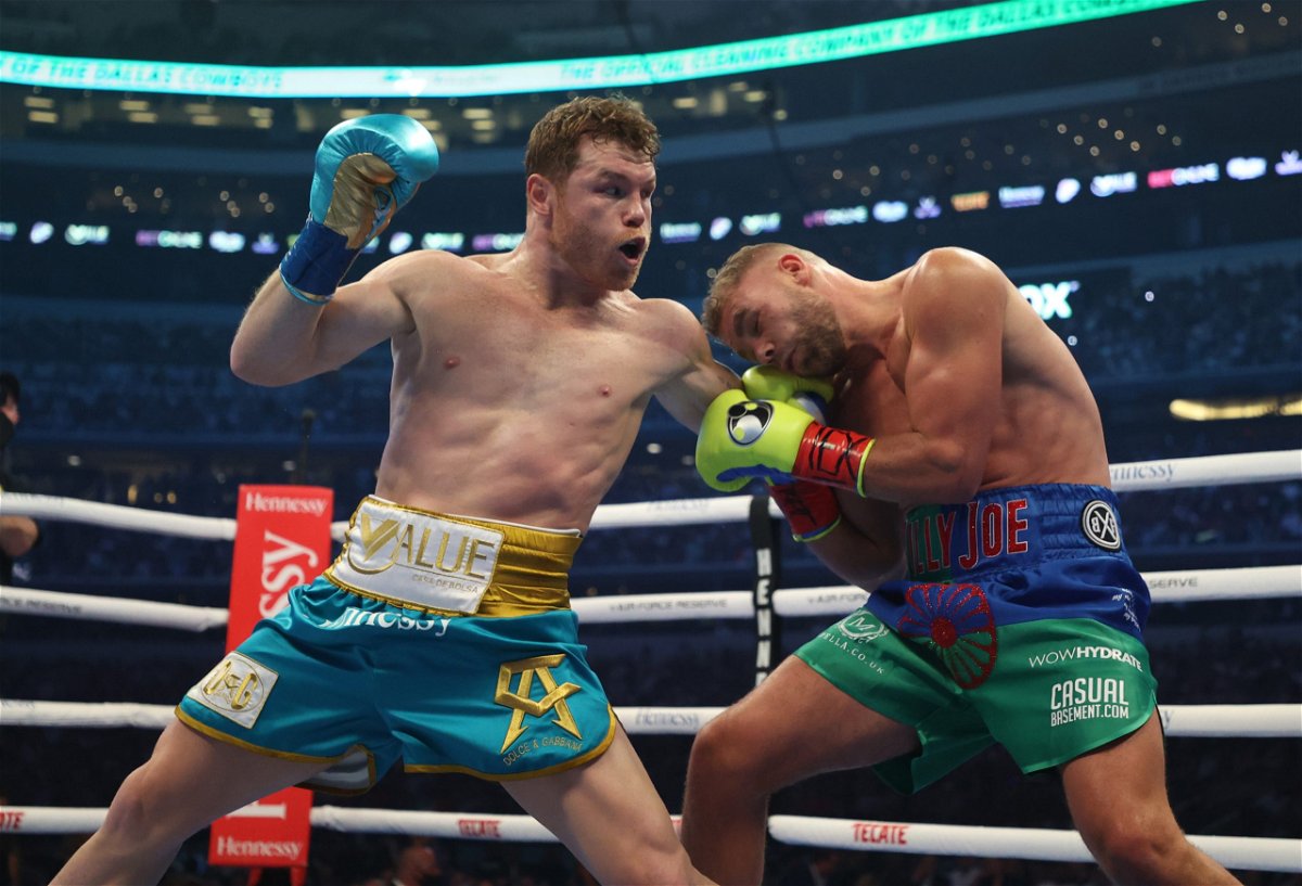 Canelo Alvarez punches Billy Joe Saunders during their fight for Alvarez's WBC and WBA super middleweight titles and Saunders' WBO super middleweight title at AT&T Stadium in Arlington, Texas.