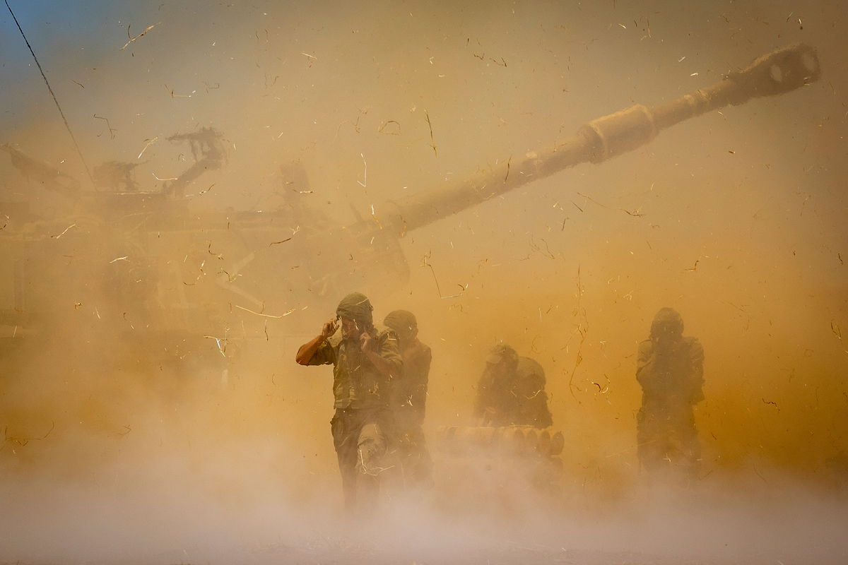 An Israeli artillery unit fires toward targets in Gaza Strip, at the Israeli Gaza border.