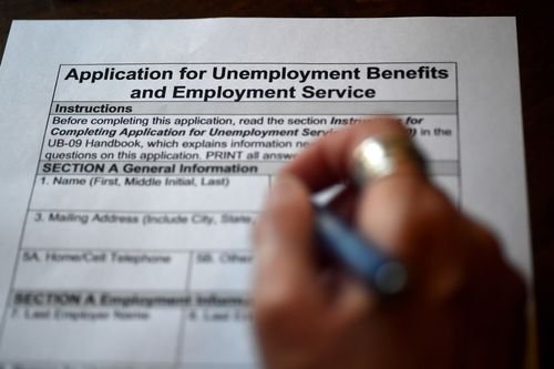 An unemployed worker fills out an application for jobless benefits.