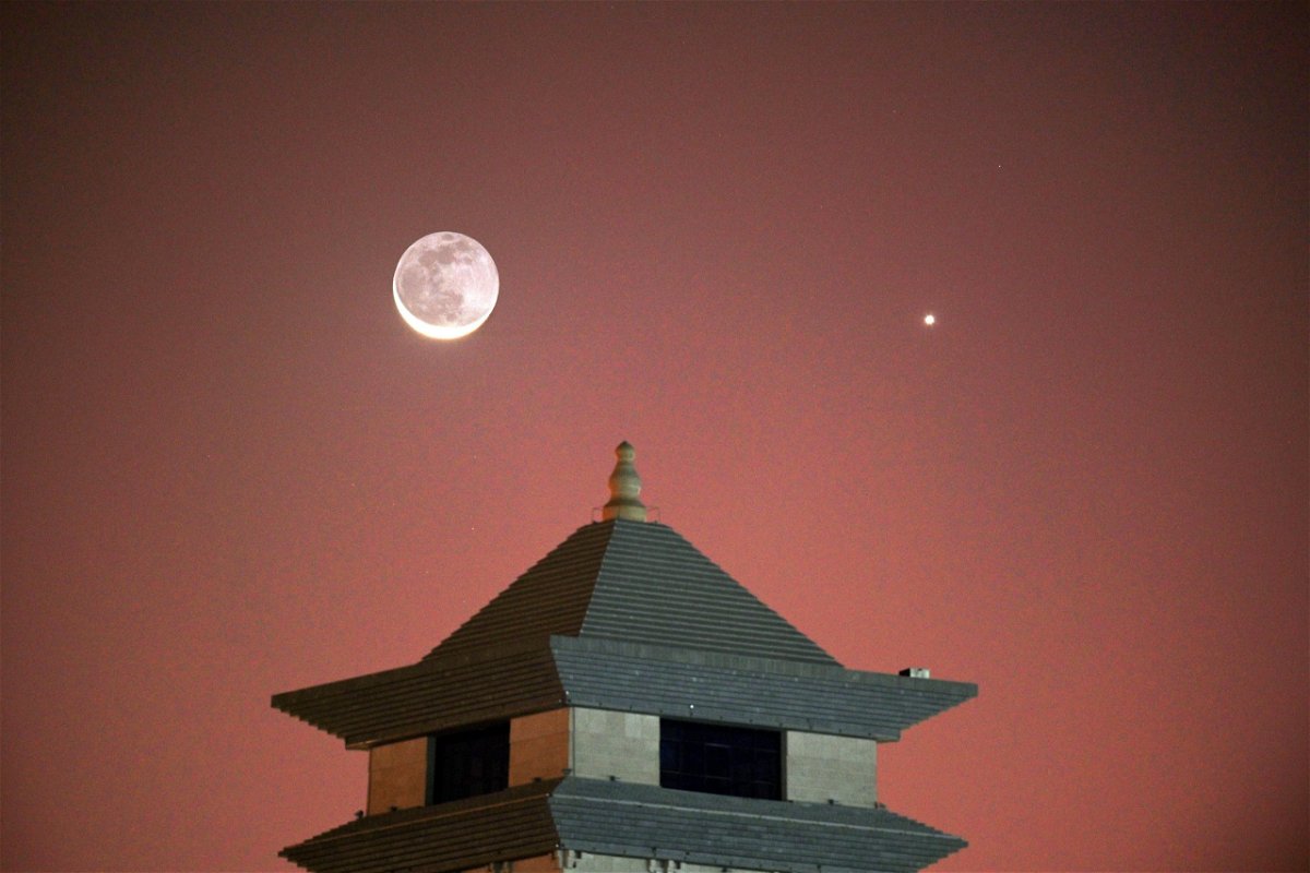 Venus appears in the night sky near a crescent moon in China.