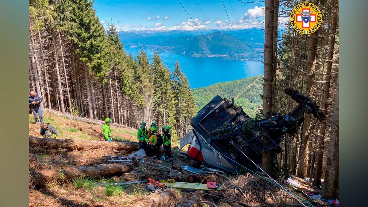 Rescuers work by the wreckage of a cable car after it collapsed near the summit of the Stresa-Mottarone line in the Piedmont region, northern Italy.