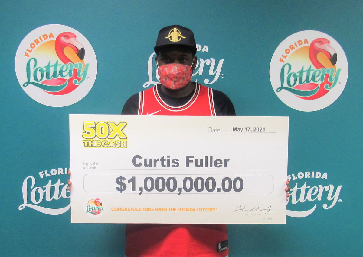 Curtis Fuller poses with an oversized lottery check.