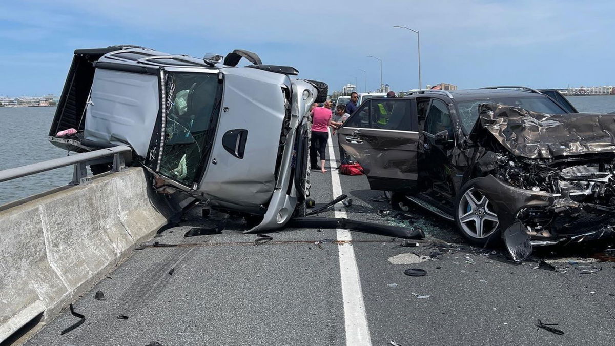 The scene of a crash that left a car dangling off the guardrail of a bridge in Ocean City, Maryland.