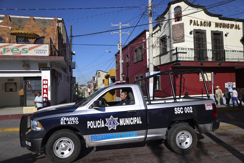 A policeman drives past town hall in Apaseo El Alto, Guanajuato state, Mexico.