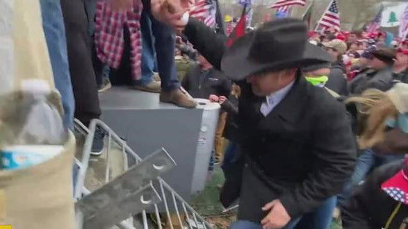 Couy Griffin scales a barricade during the U.S. Capitol riot on Jan. 6.