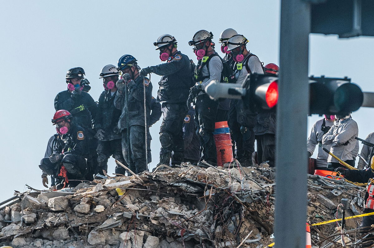 <i>Giorgio Viera/AFP/Getty Images</i><br/>Search and Rescue teams look for possible survivors in the partially collapsed 12-story Champlain Towers South condo building on June 28