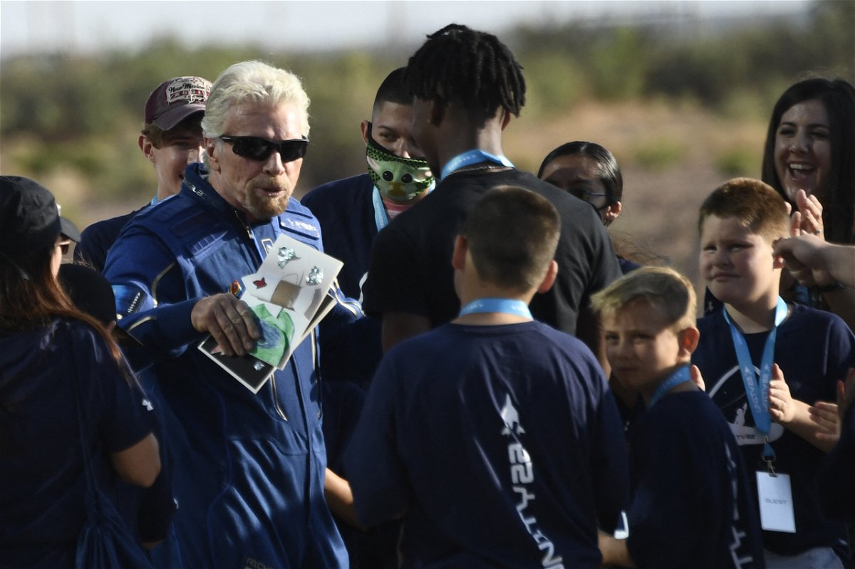 <i>Patrick T. Fallon/AFP/Getty Images</i><br/>Richard Branson receives some cards from children as he walks out from Spaceport America