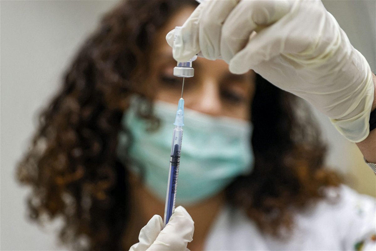 <i>JACK GUEZ/AFP/AFP via Getty Images</i><br/>A medic prepares a dose of the Pfizer-BioNTech Covid-19 vaccine.