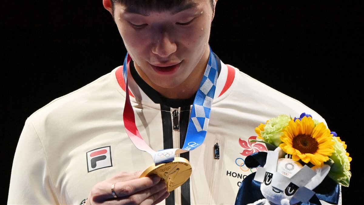 <i>Fabrice Coffrini/AFP/Getty Images</i><br/>Fencing gold medallist Cheung Ka Long of Hong Kong looks at his medal while on the podium during the medal ceremony for the Men's Individual Foil during the Tokyo 2020 Olympic Games at the Makuhari Messe Hall in Chiba City