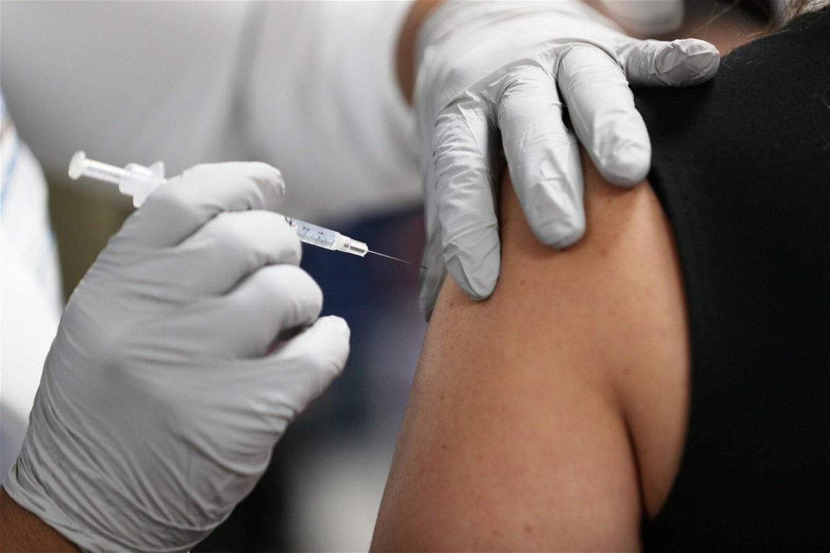 <i>Joe Raedle/Getty Images</i><br/>A healthcare worker receives a Pfizer-BioNtech Covid-19 vaccine.
