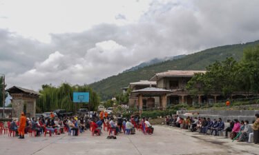 People queue up to register themselves and get inoculated with the Covid-19 coronavirus vaccine at a temporary vaccination centre in Thimpu on July 20.