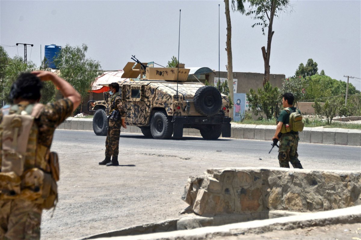 <i>Javed Tanveer/AFP/Getty Images</i><br/>Afghan security personnel stand guard along a road during an ongoing fight between Afghan forces and Taliban fighters in Kandahar on July 9.