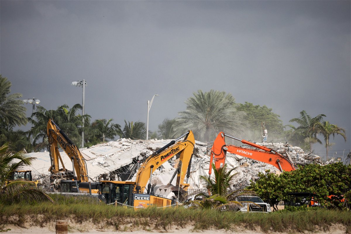 <i>Anna Moneymaker/Getty Images</i><br/>Rescue workers use excavators to dig through the rubble of the collapsed 12-story Champlain Towers South condo building  in Surfside.