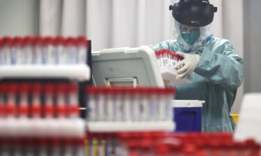 A medical worker works on samples from local residents to be tested for Covid-19 at a laboratory in Nanjing