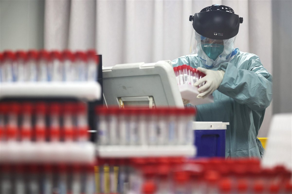 <i>Yang Bo/China News Service/Getty Images</i><br/>A medical worker works on samples from local residents to be tested for Covid-19 at a laboratory in Nanjing