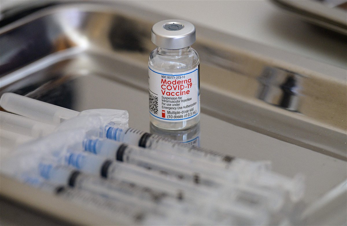 <i>Angela Weiss/AFP/Getty Images</i><br/>A vial of the Moderna Covid-19 vaccine and syringes sit prepared at a pop up vaccine clinic.