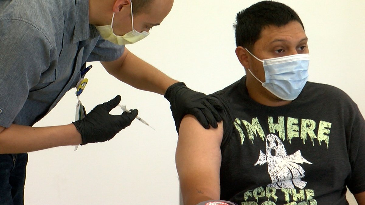 A young person gets a shot at a Texas Tech vaccination drive.