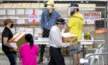 Former Secretary of State Ken Bennett (right) works to move ballots from the 2020 general election at Veterans Memorial Coliseum on May 1