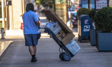 Online prices jumped 3.1% year-over-year in July. A U.S. Postal Service worker makes a delivery in San Francisco