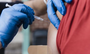 A healthcare worker administers a dose of the Pfizer-BioNTech Covid-19 vaccine at a pop up vaccination site in Missouri on August 3.