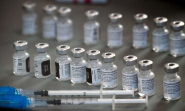 Vials of the Pfizer-BioNTech Covid-19 vaccine are prepared to be administered to front-line health care workers under an emergency use authorization at a drive-up vaccination site from Renown Health in Reno