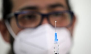 A health workers fills a syringe with a dose of the Pfizer-BioNTech vaccine against Covid-19 at a vaccination centre in Santiago