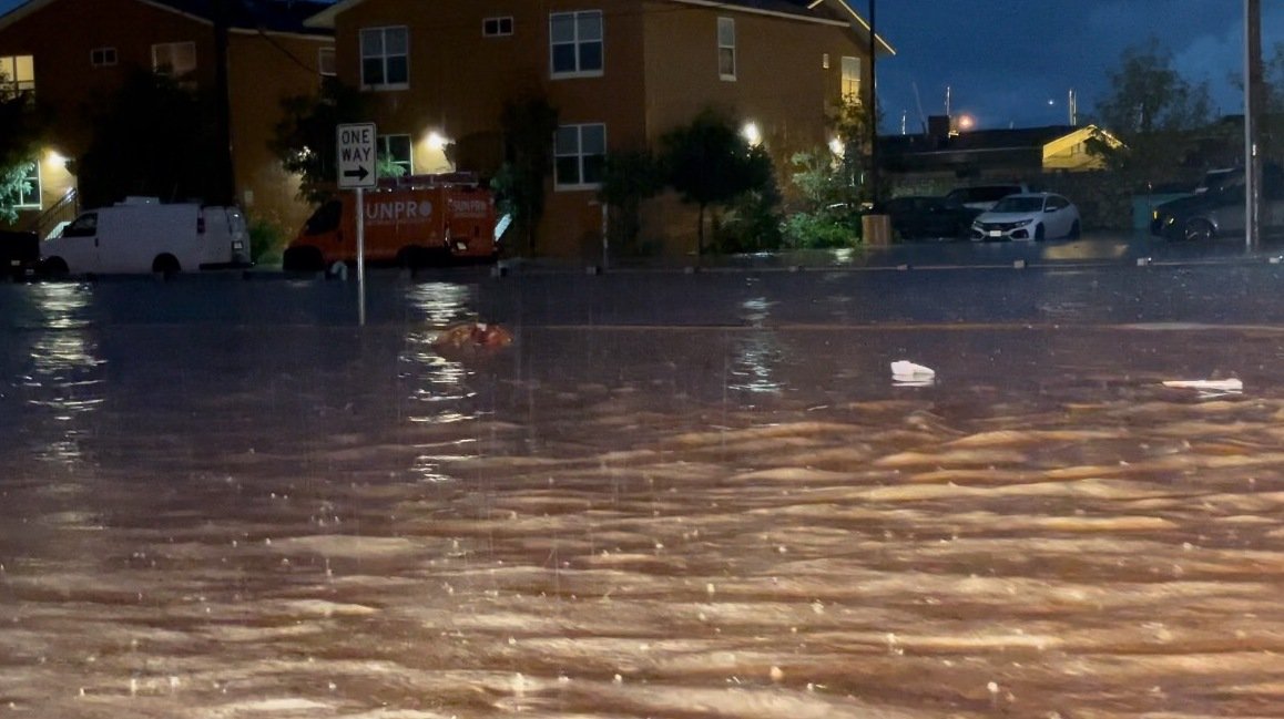 Floodwaters from heavy rain overwhelm a street in northeast El Paso.
