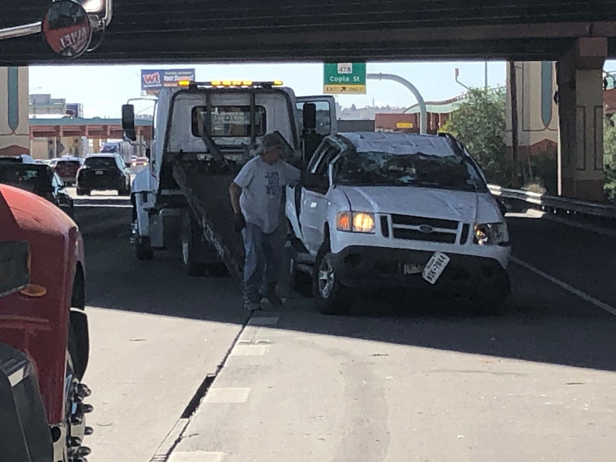 A car involved in a wreck along I-10 near the Spaghetti Bowl is towed away.