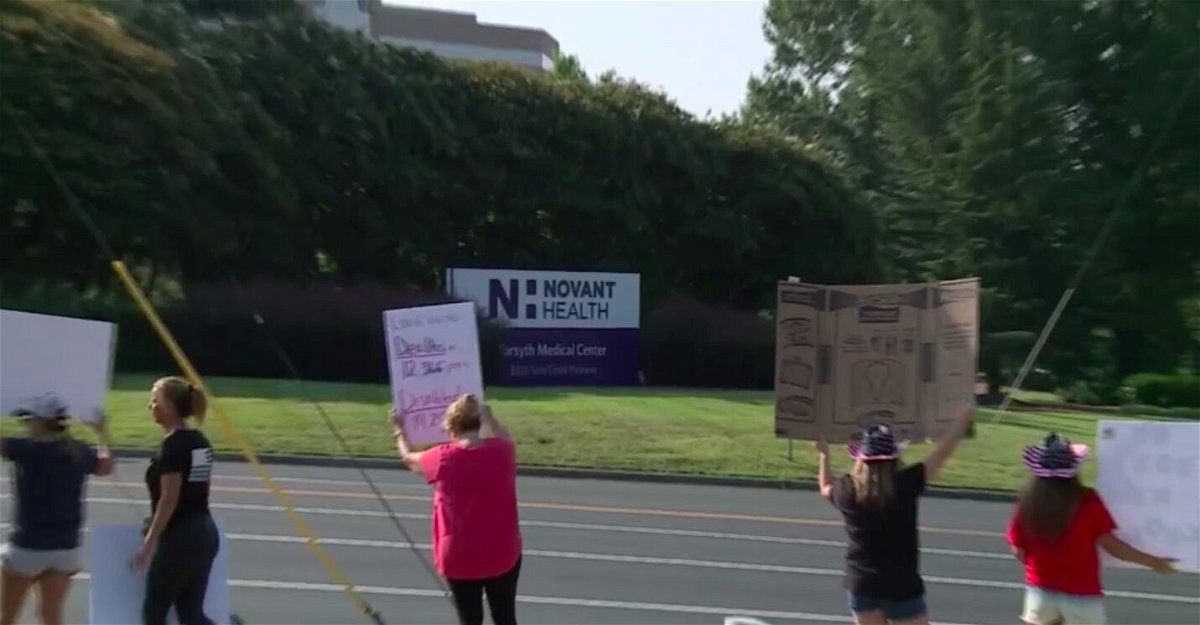 <i>WXII</i><br/>Healthcare workers protest vaccine mandate outside Novant Health Forsyth Medical Center in Winston-Salem