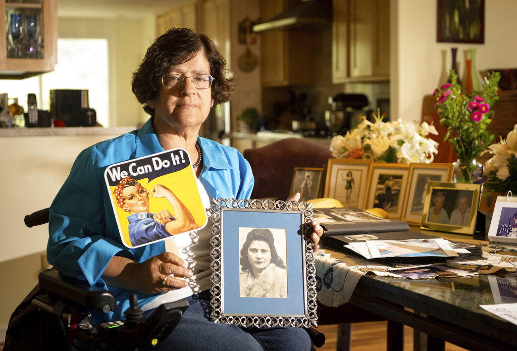 Dorene Giacopini holds up a photo of her mother Primetta Giacopini.