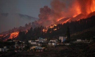 A river of lava flowing from the volcano approaches houses on Spain's La Palma island on Sunday.