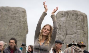 A woman dances as druids