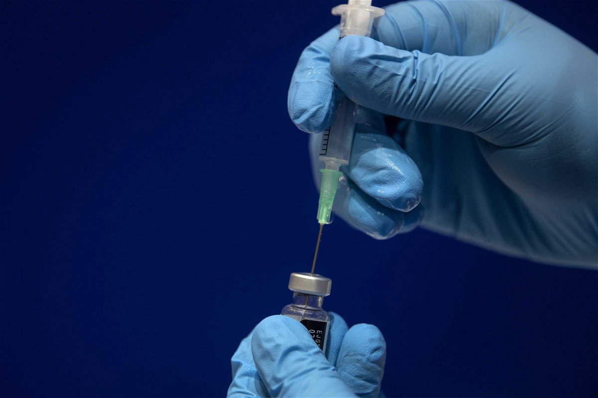<i>Victoria Jones/Pool/Getty Images</i><br/>A healthcare worker fills a syringe with Pfizer Covid-19 vaccine.