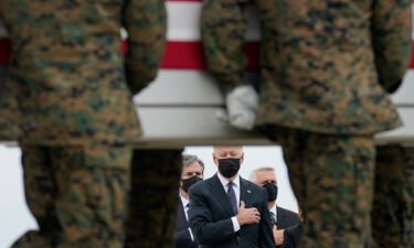 President Joe Biden watches as a carry team moves a transfer case containing the remains of Marine Corps Lance Cpl. Kareem M. Nikoui
