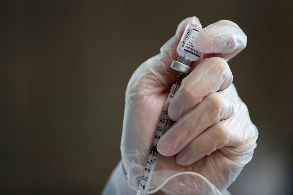 <i>Caroline Brehman/EPA-EFE/Shutterstock</i><br/>A health care worker fills a syringe with a dose of the Pfizer/BioNTech Covid-19 vaccine at a clinic in California State University. Los Angeles County began offering booster shots Friday.