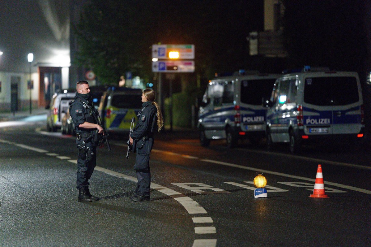 <i>Henning Kaiser/picture alliance/Getty Images</i><br/>Police officers block a street in Hagen on Wednesday evening after warnings of a terror threat against a synagogue.