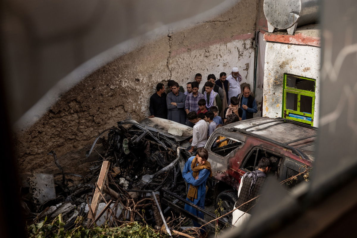 Relatives and neighbors inspect damage in the cramped courtyard of a house in Kabul, Afghanistan on Monday, Aug. 30, 2021, from what they said was a U.S. drone strike.