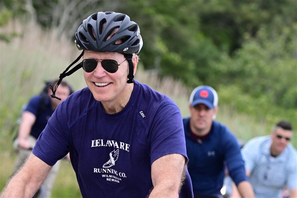 <i>JIM WATSON/AFP/Getty Images</i><br/>US President Joe Biden rides his bicycle in Cape Henlopen State Park on June 3