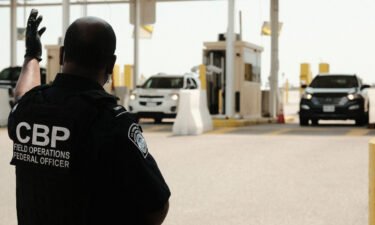 U.S. Customs and Border Protection agents direct vehicles re-entering the U.S. from Canada