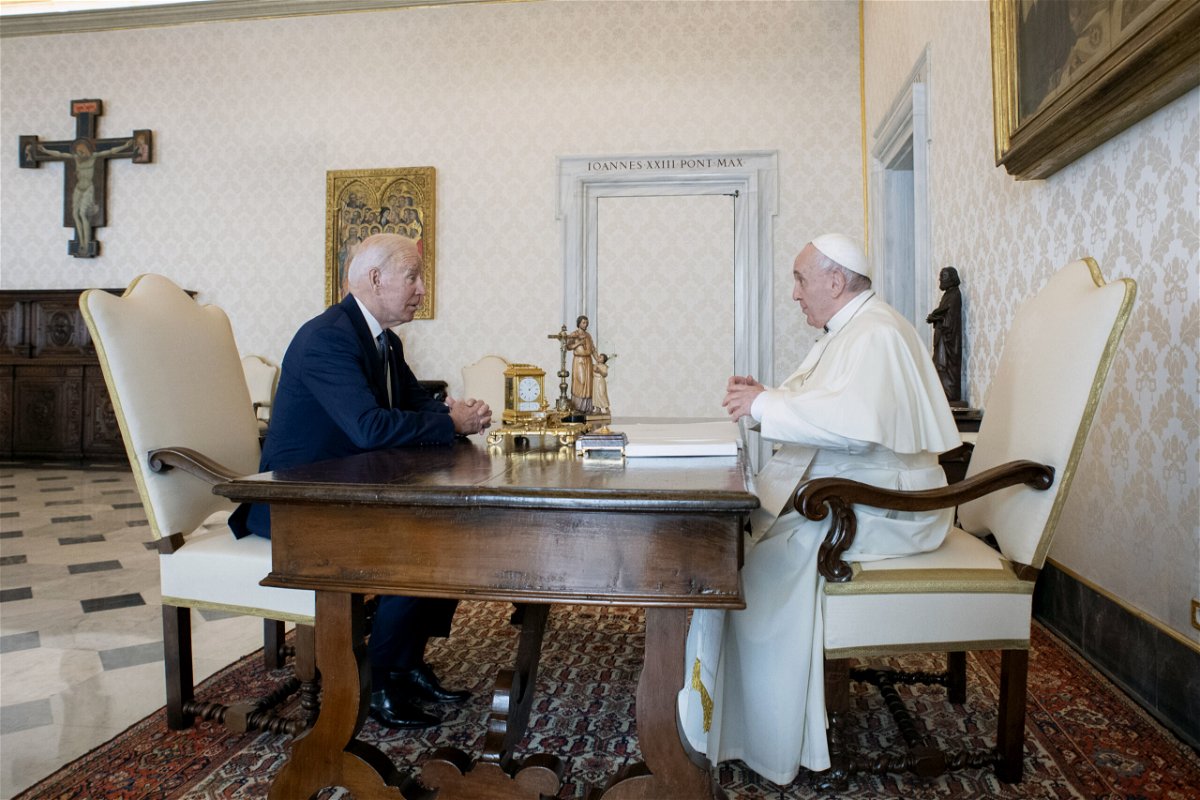 US President Joe Biden, left, talks with Pope Francis as they meet at the Vatican.